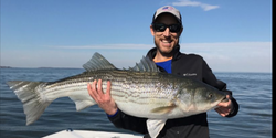 Reeling in Striped Bass at Maryland fish trip